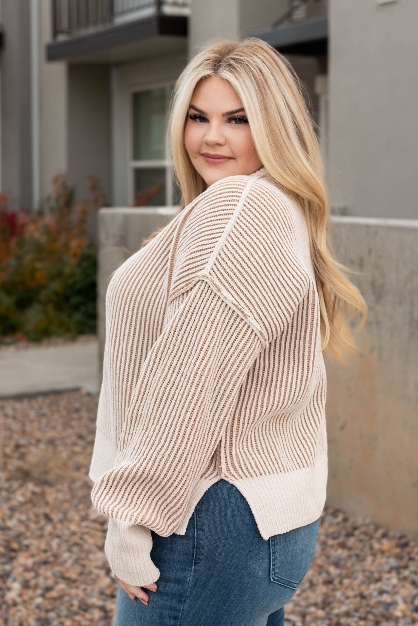 Side view of the plus size cream knit sweater
