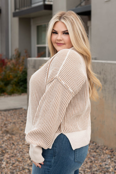 Side view of the plus size cream knit sweater