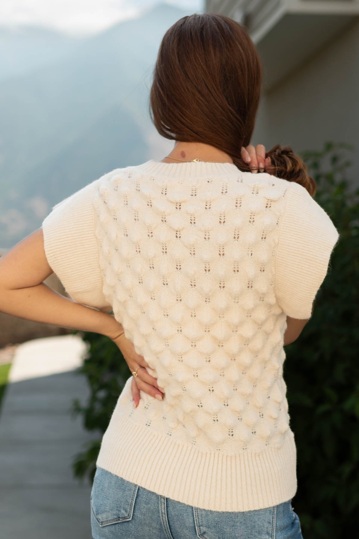 Back view of a short sleeve cream top