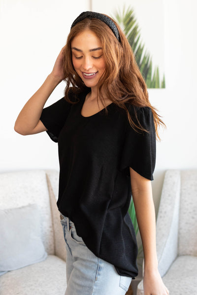 Side view of a short sleeve black top