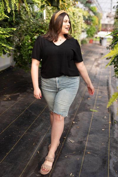 Front view of the plus size short sleeve black top