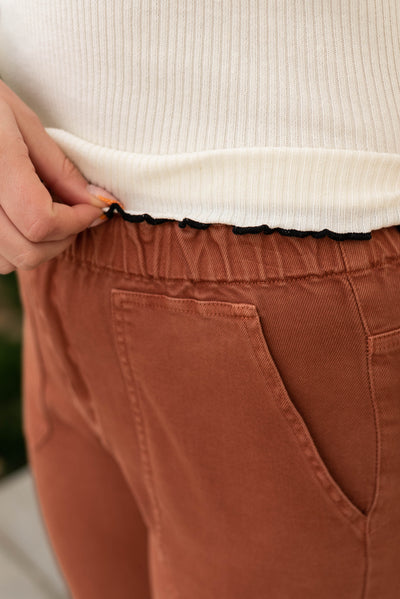 Black trim on the ivory high neck rib top