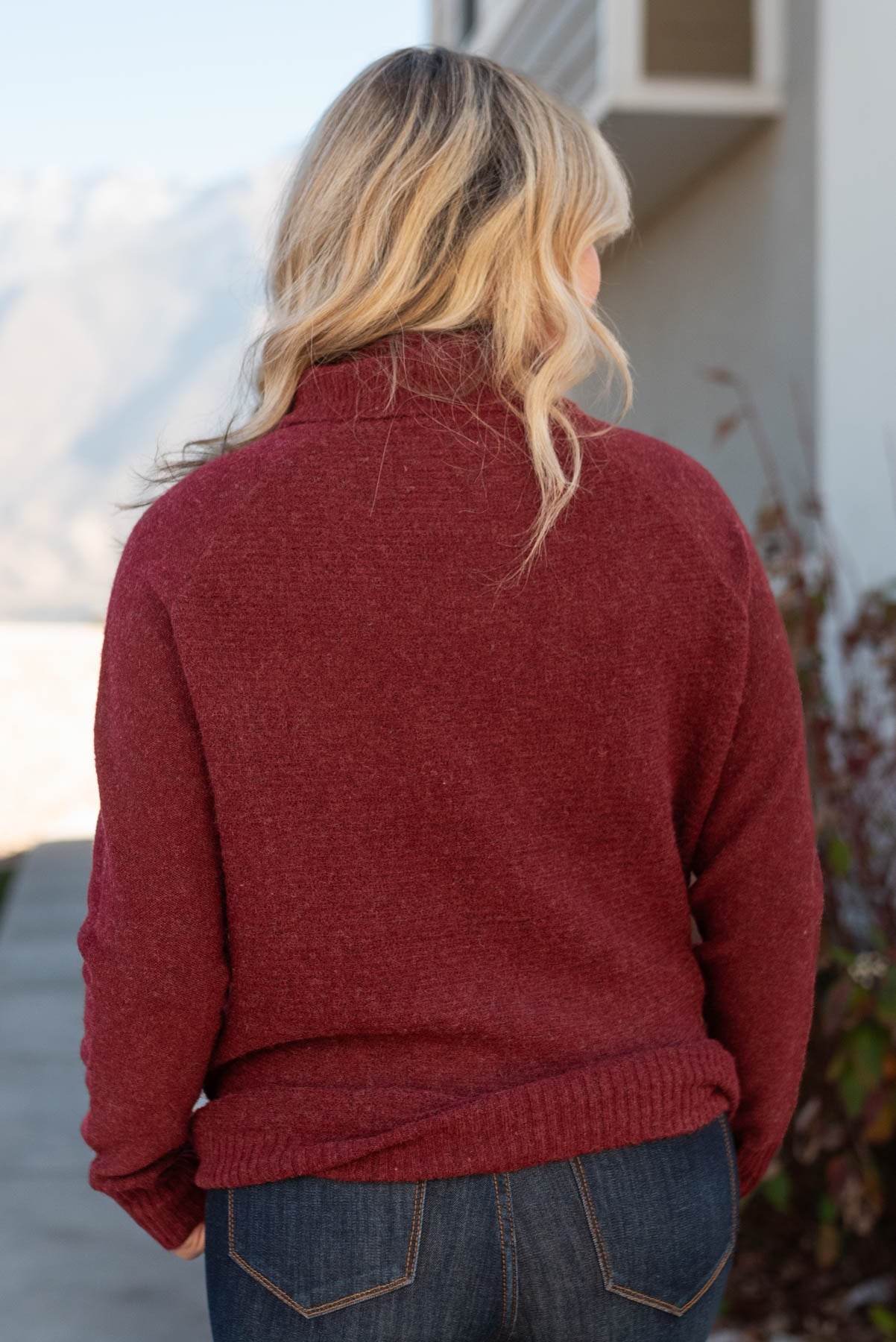 Back view of a burgundy sweater