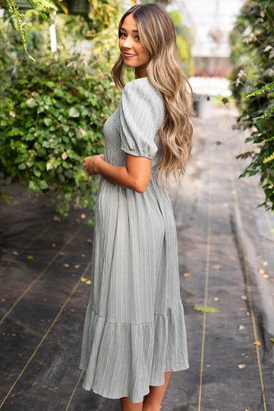 Side view of the dusty blue smocked dress