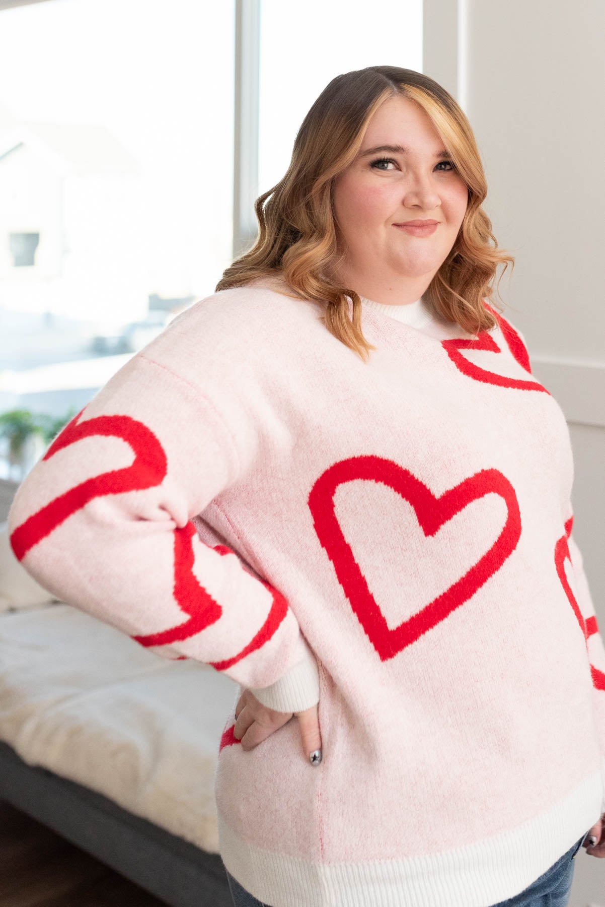 Side view of the plus size red heart sweater