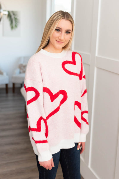 Side view of a red heart sweater