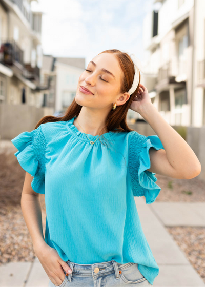 Turquoise ruffle blouse with short sleeves