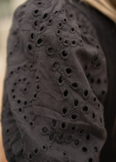 Eyelet sleeves on a black top