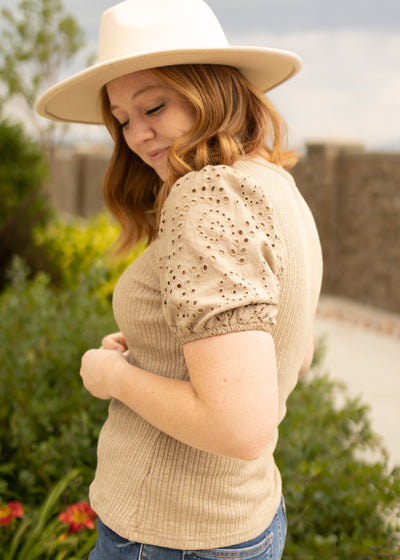 Side view of a short sleeve taupe top
