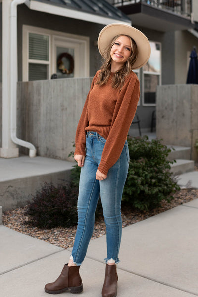 Side view of a small camel knit sweater