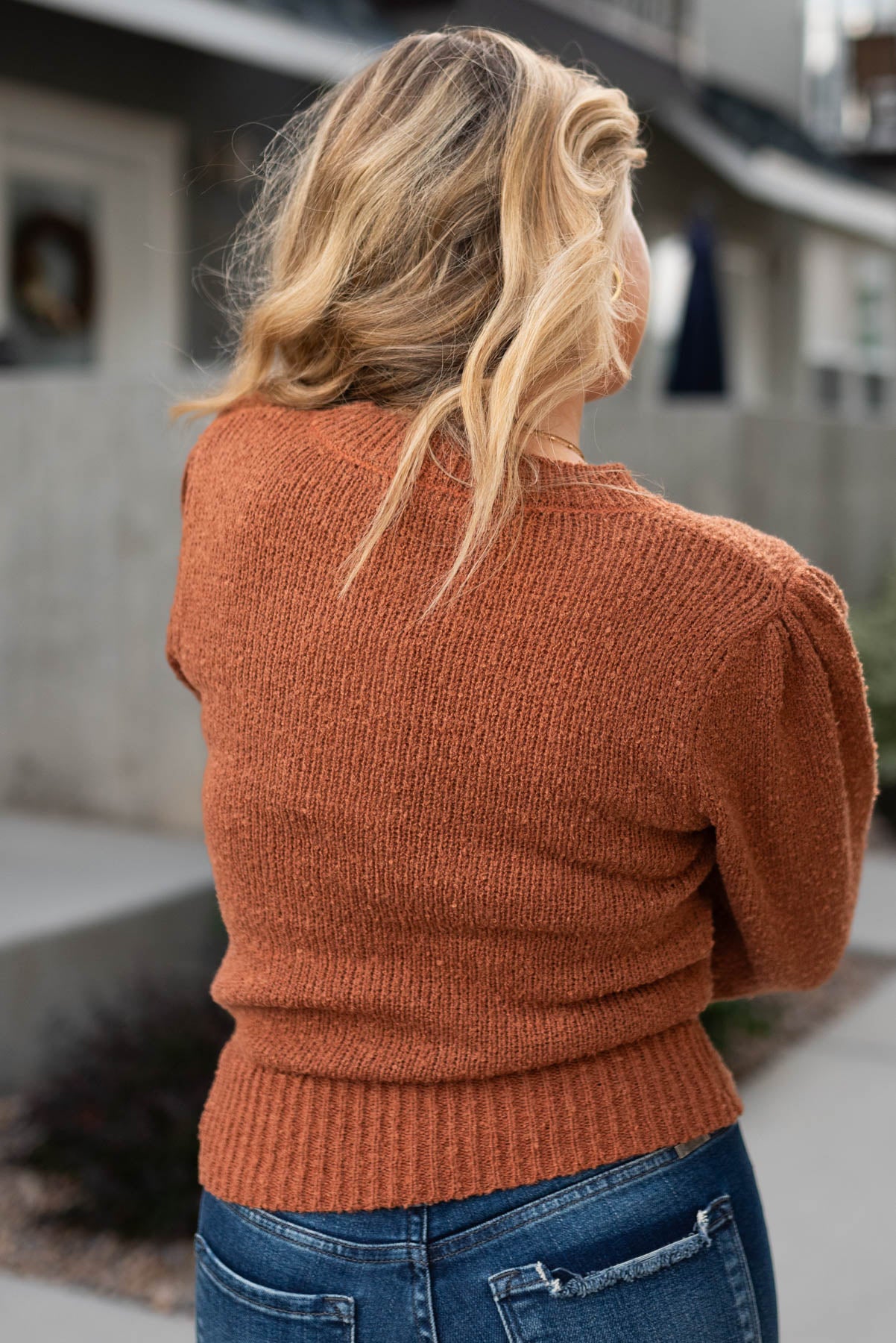Back view of a camel knit sweater