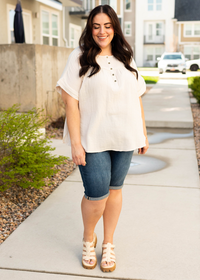 Plus size cream button top with cuffs on the short sleeves