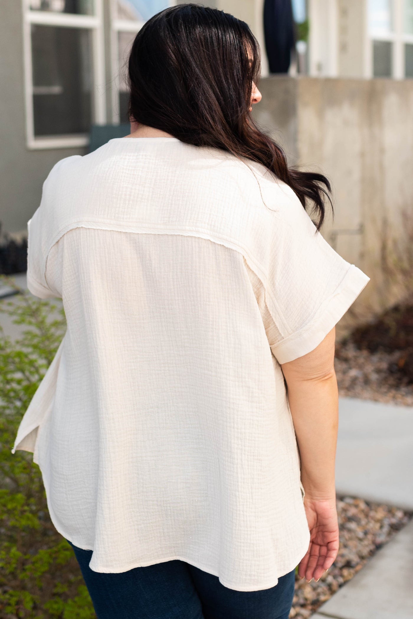 Back view of the plus size cream button top