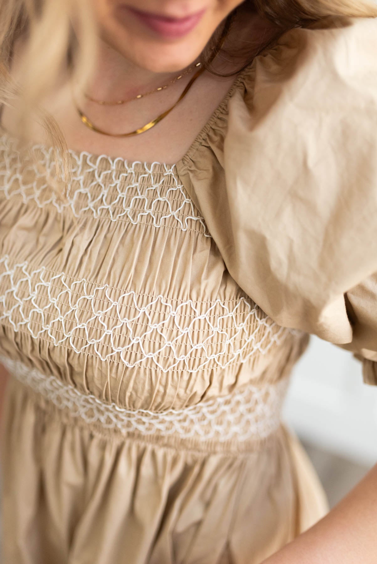 Taupe dress with a close up of the smocked bodice