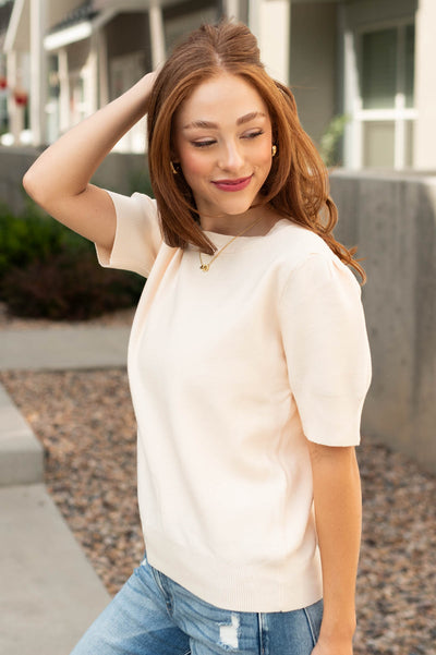 Side view of a ivory sweater