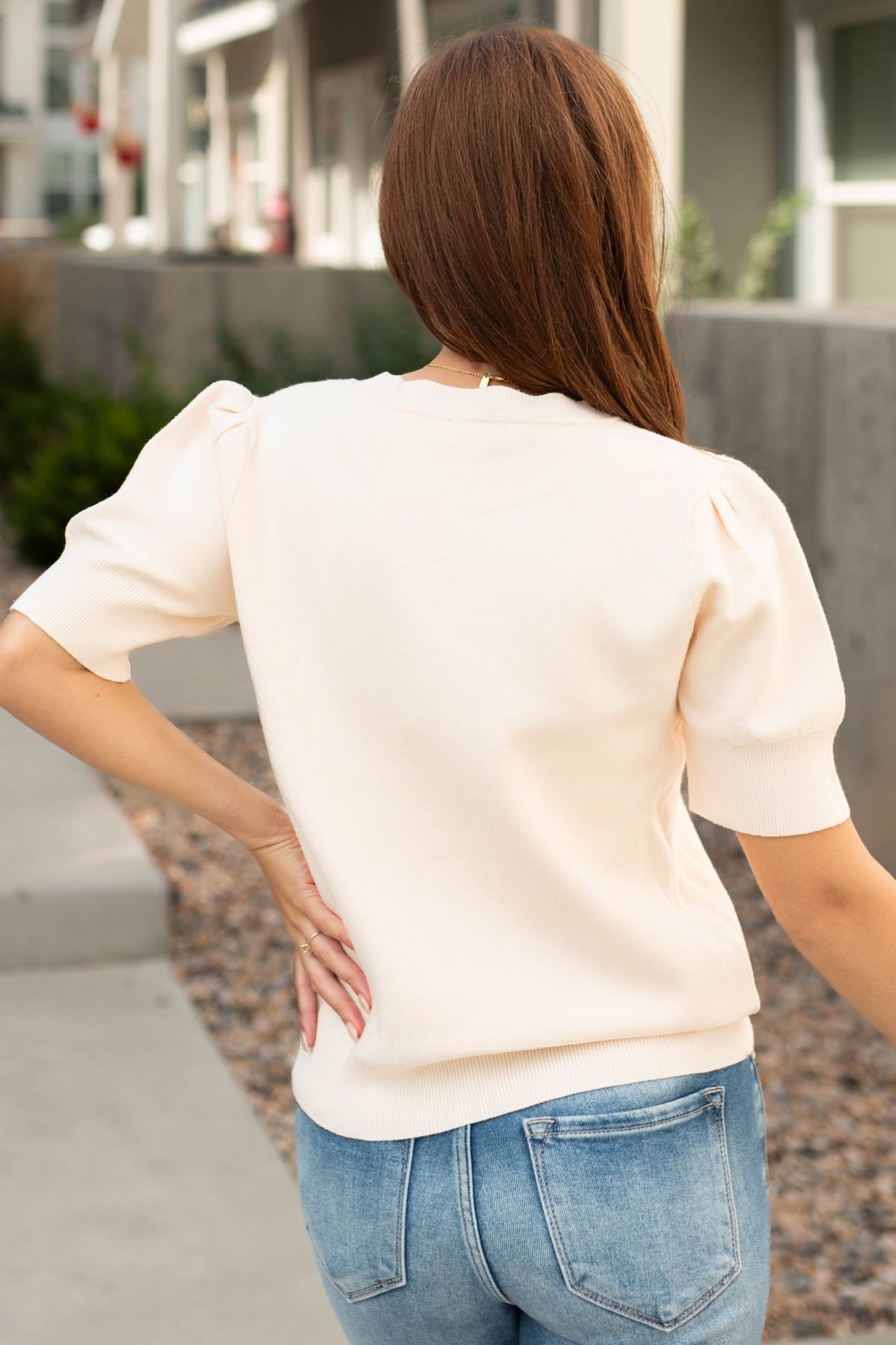 Back view of a ivory sweater