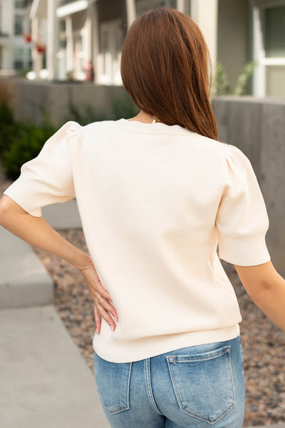 Back view of a ivory sweater