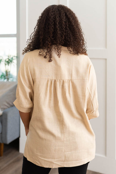 Back view of the taupe linen button down shirt