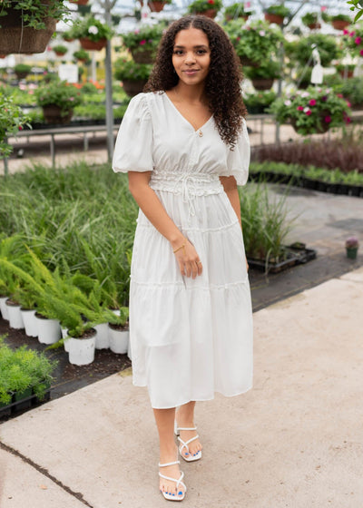 Tiered skirt and puff sleeves on the ivory vneck dress
