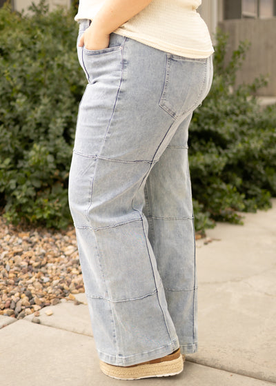 Side view of plus size light denim jeans with pockets