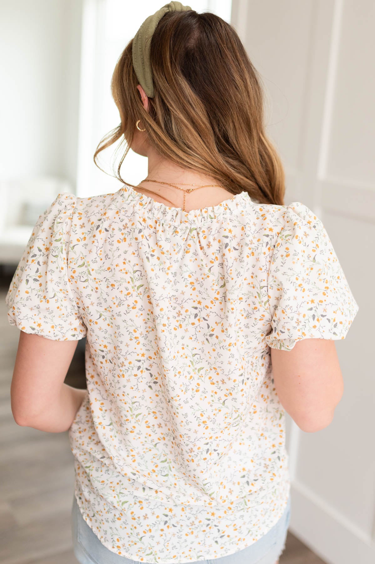 Back view of the cream floral printed blouse