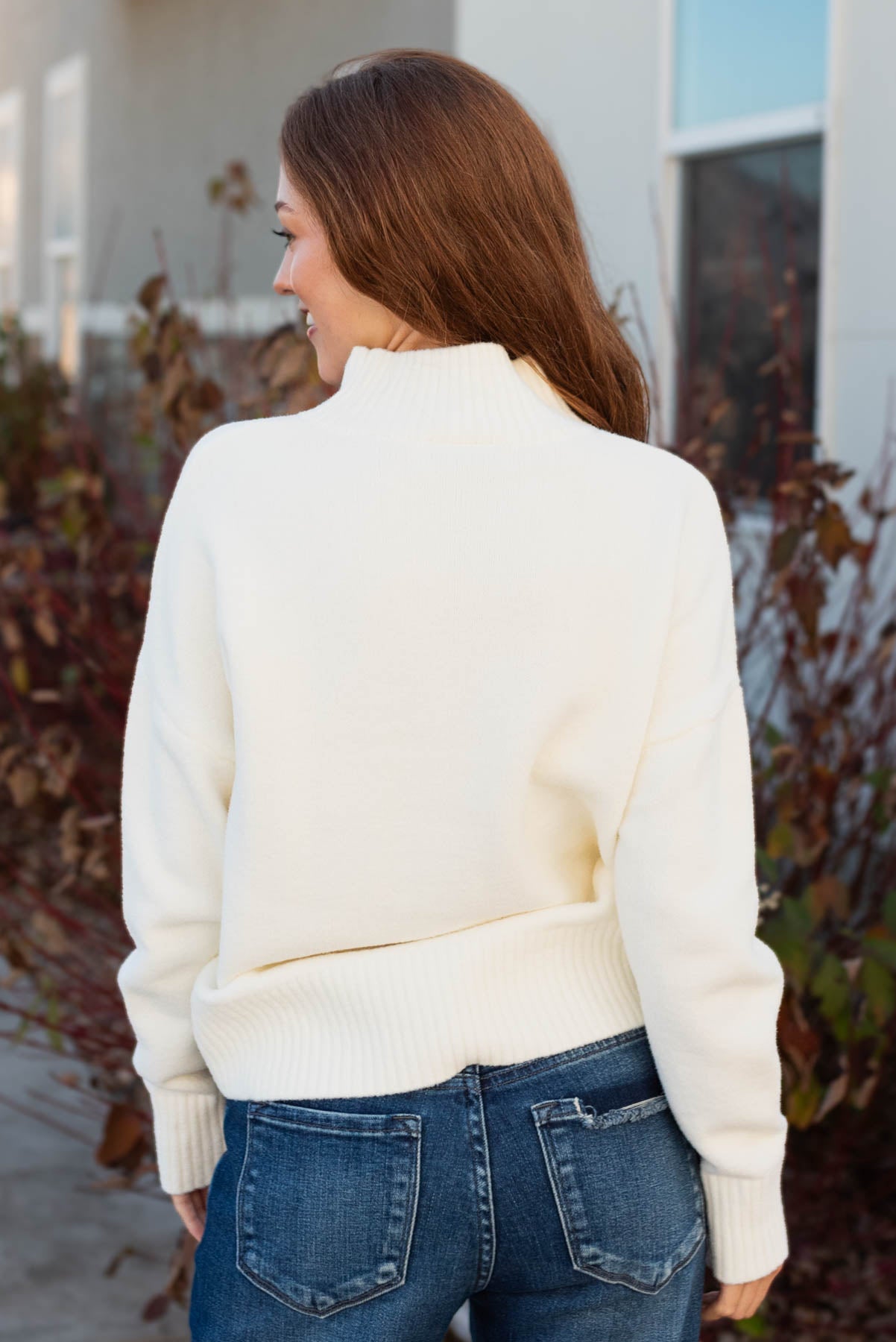 Back view of the long sleeve ivory sweater