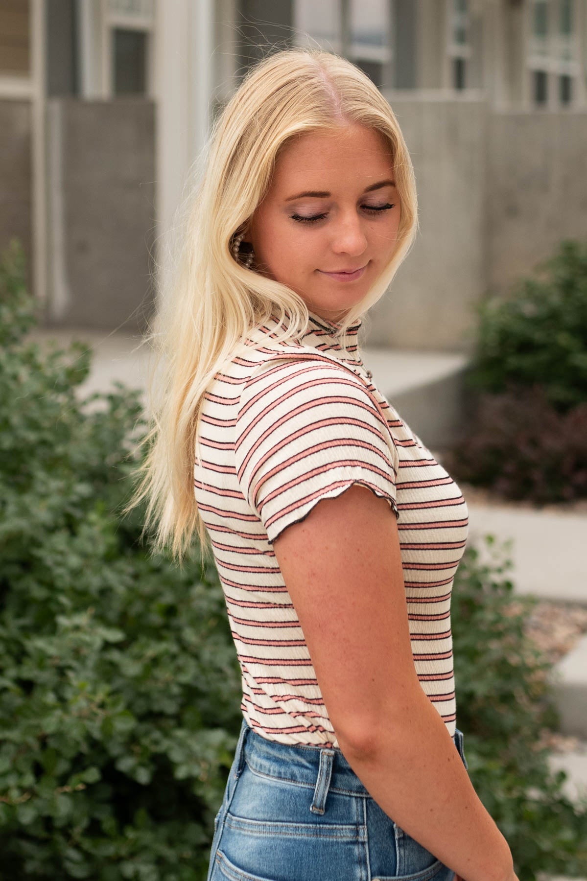 Side view of a beige top with stripes