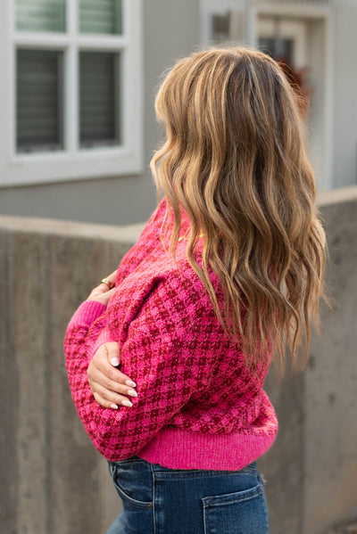 Side view of a pink pattern sweater