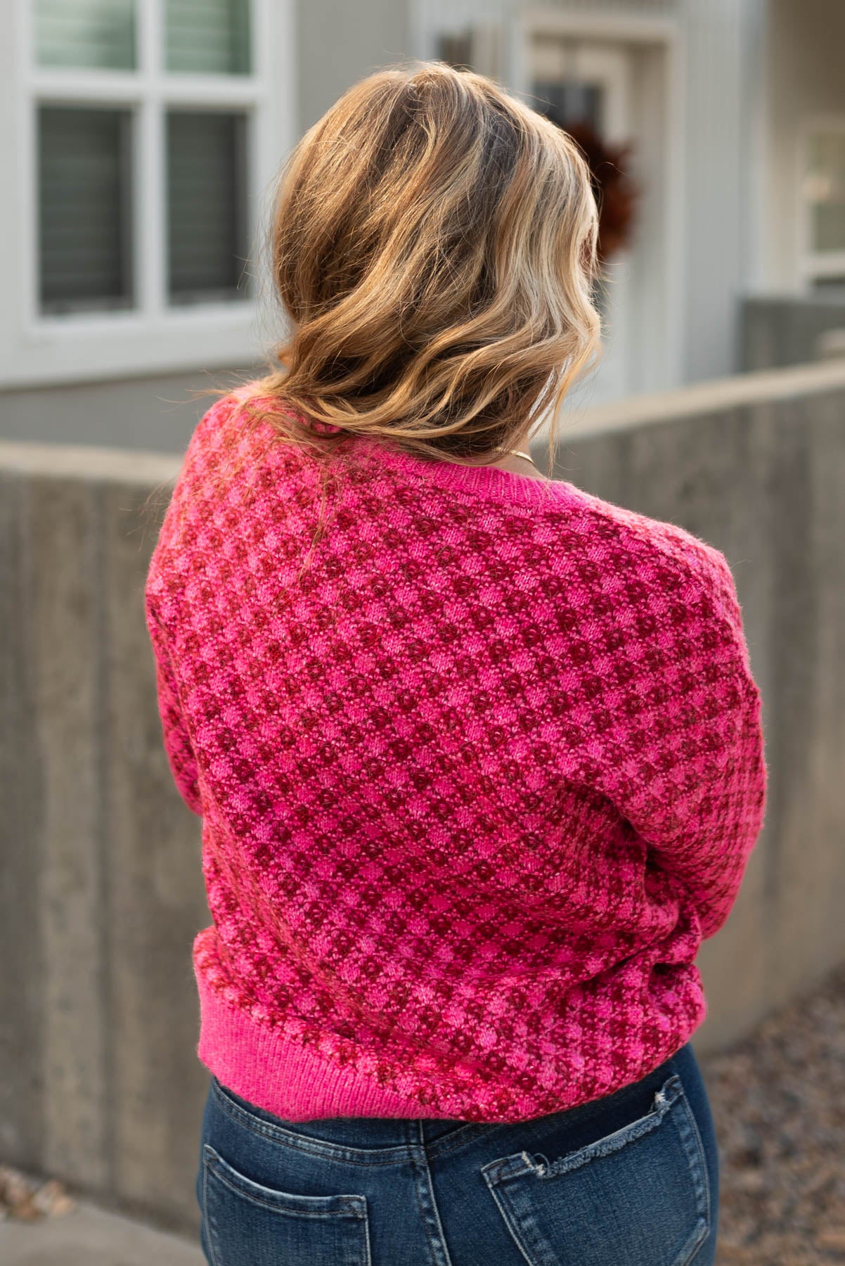 Back view of a pink pattern sweater