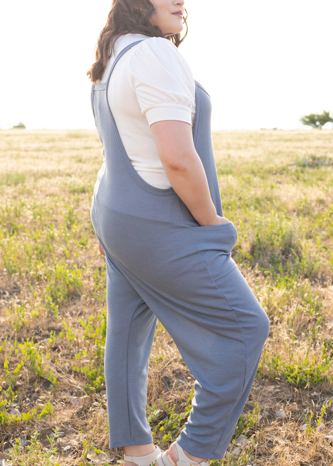 Side view of a plus size chambray jumpsuit
