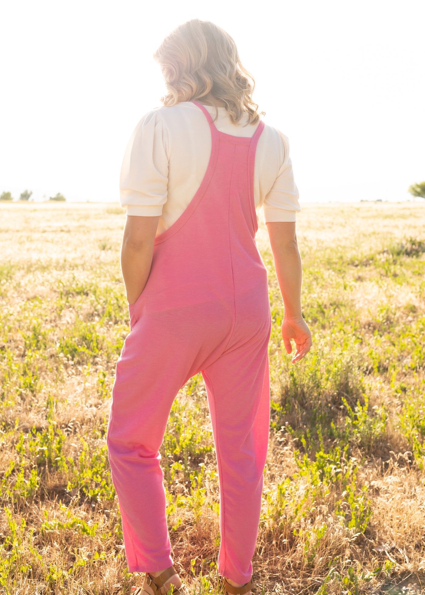 Back view of a knit hot pink jumpsuit