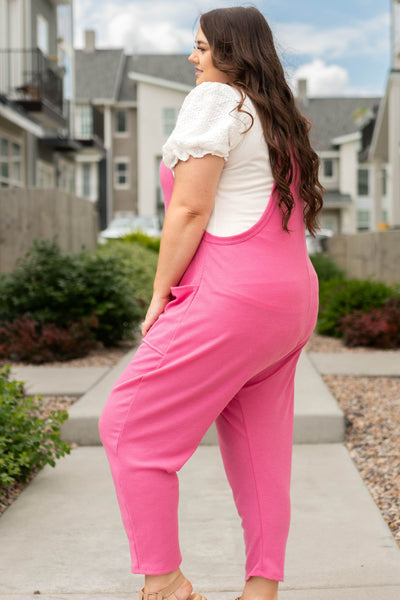 Side view of a plus size knit hot pink jumpsuit