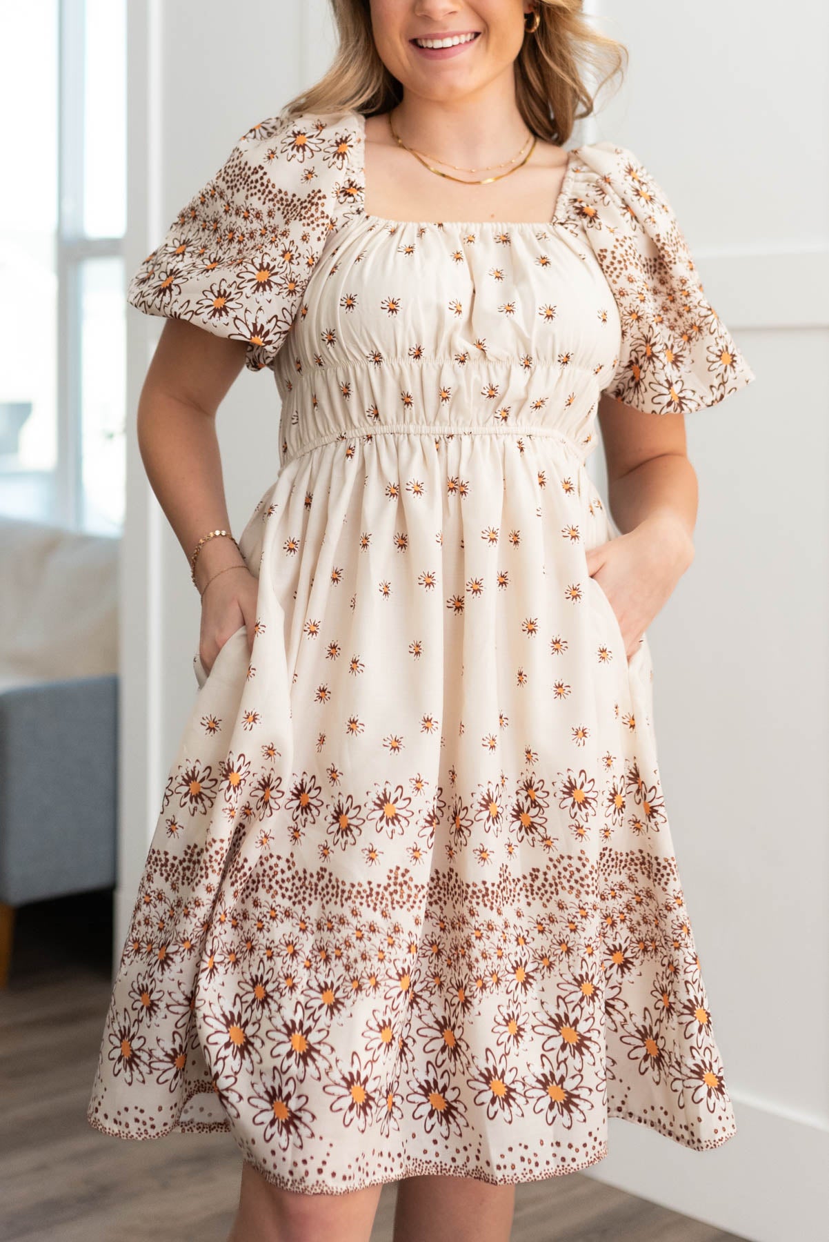Short sleeve beige daisy dress with smocking on the bodice and pockets