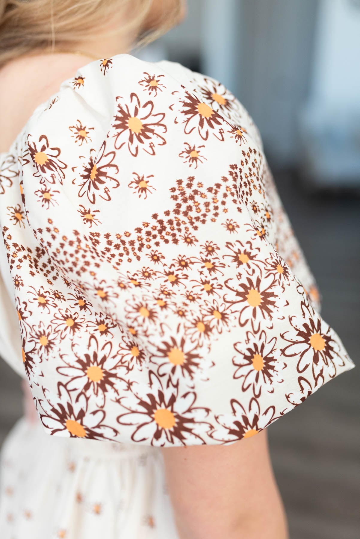 Close up of the sleeve on the beige daisy dress