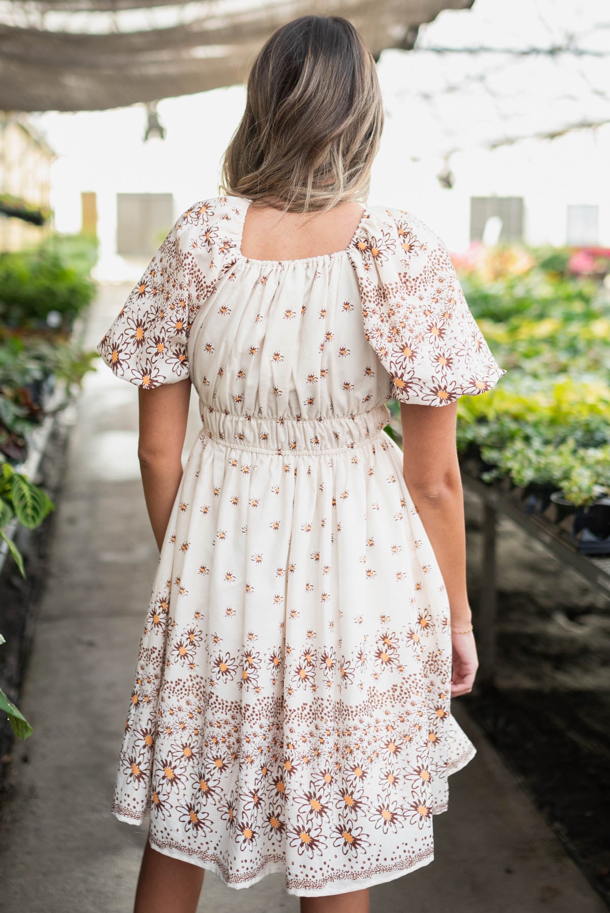 Back view of the beige daisy dress