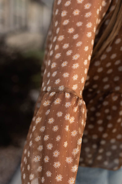 Close up of the sleeve on a brown floral top