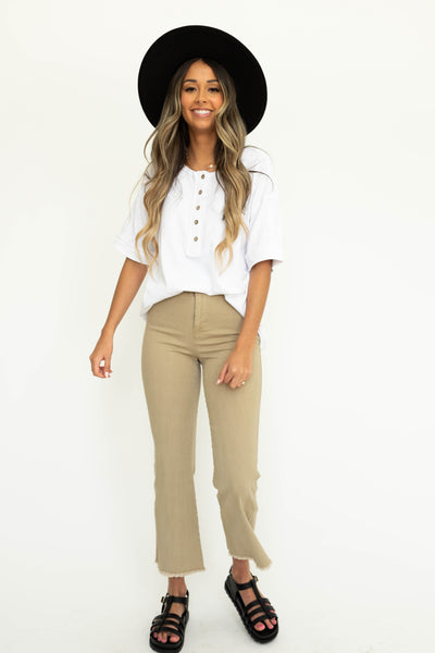 Tan ankle length pants with a frayed edge