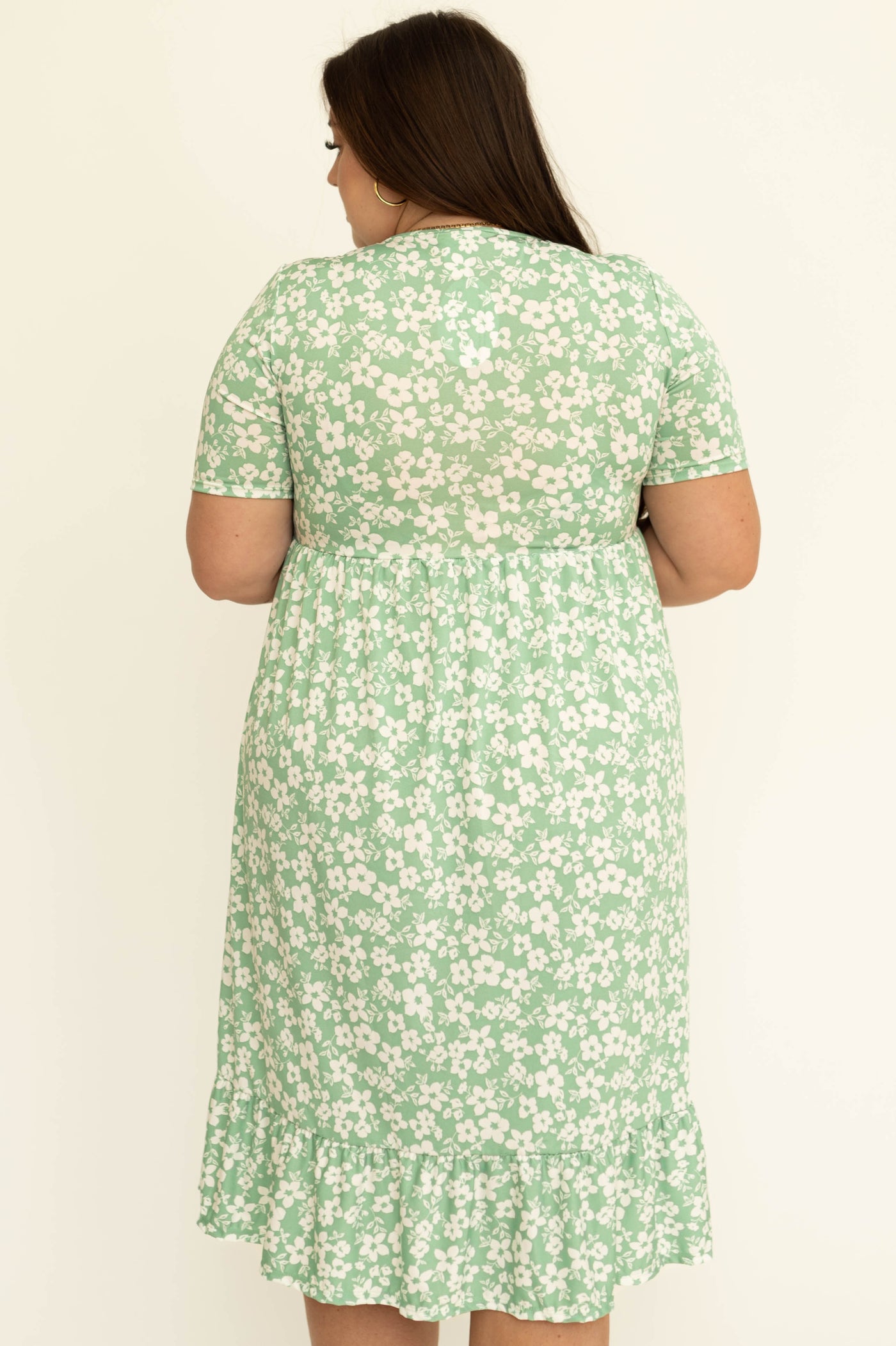 Back view of a plus size mint floral dress