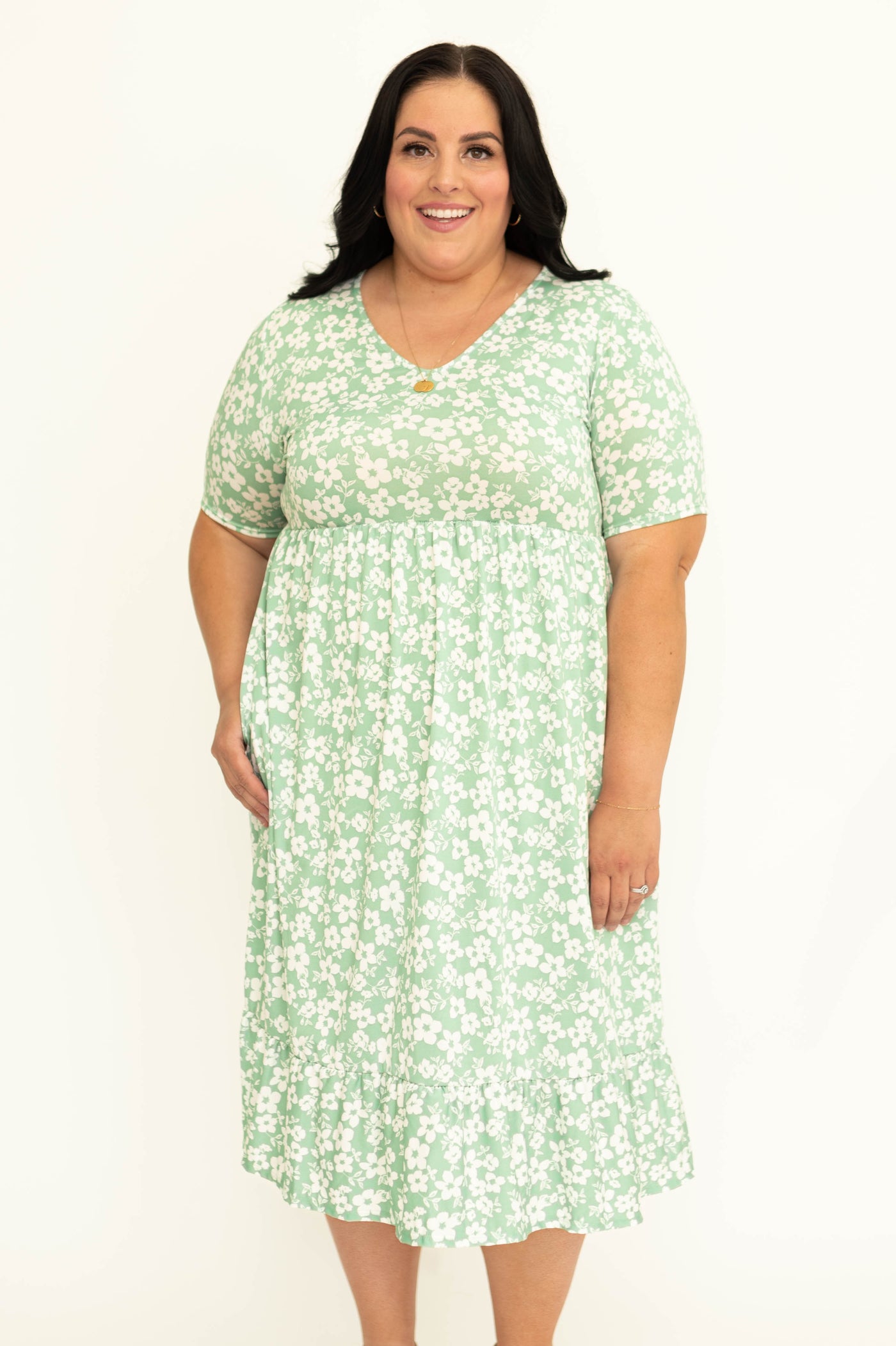 Front view of a short sleeve plus size mint floral dress