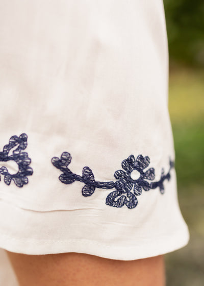Short sleeve white dress with blue embroidery on the sleeve