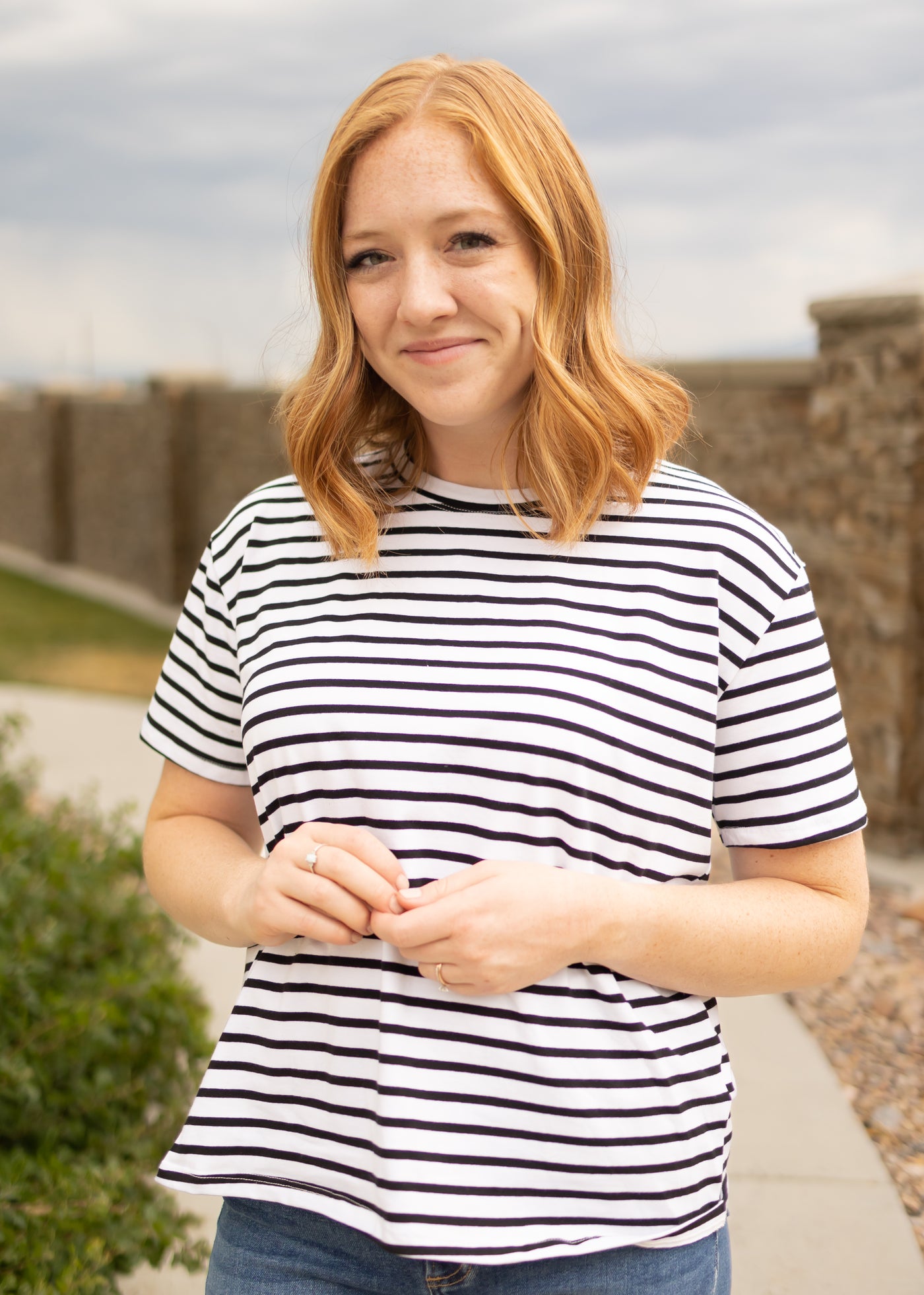 Front view of a short sleeve black top with stripes