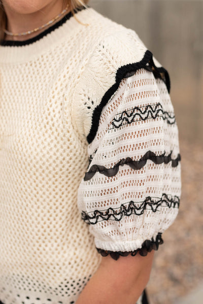 View of the sleeve on the cream puffed sleeve top