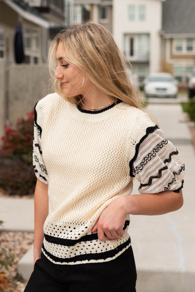 Cream puffed sleeve top with black trim