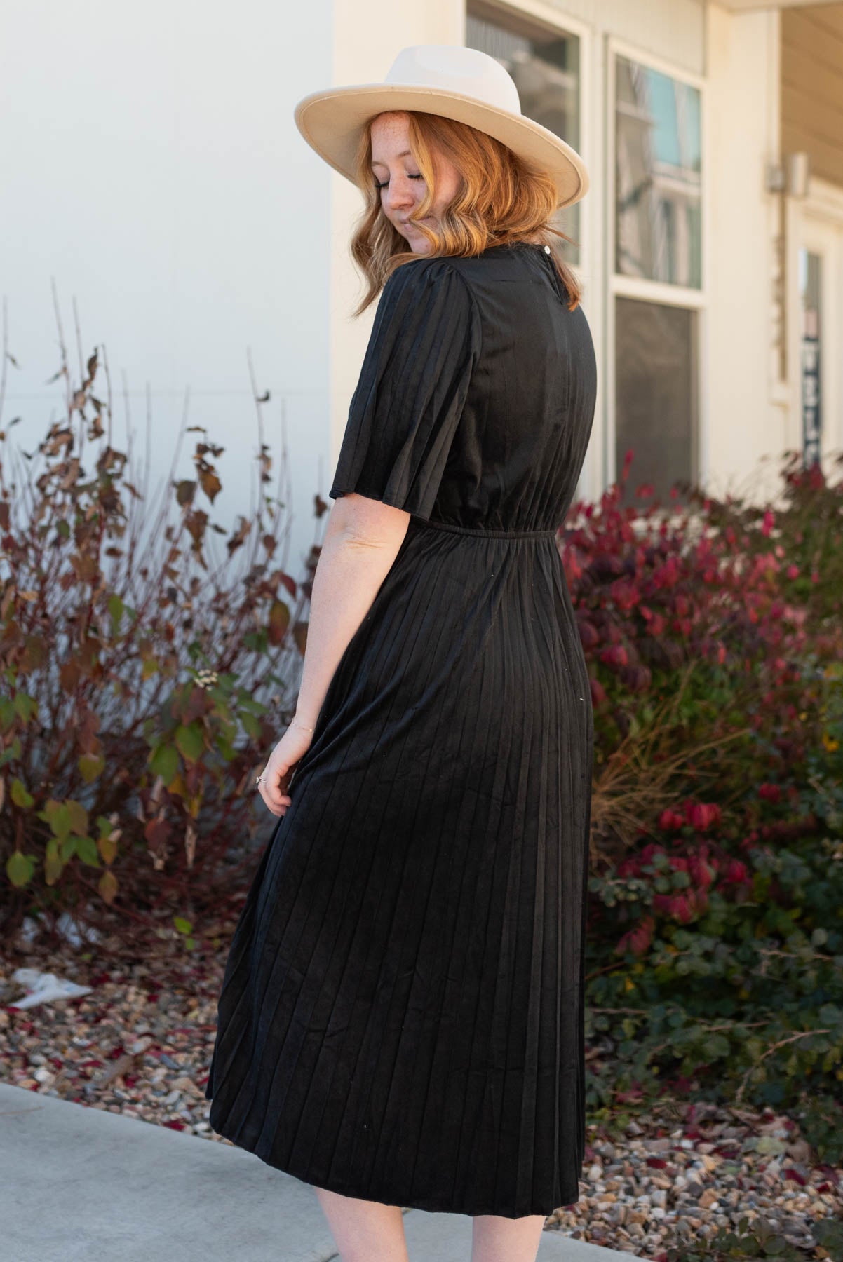 Side view of the black pleated dress
