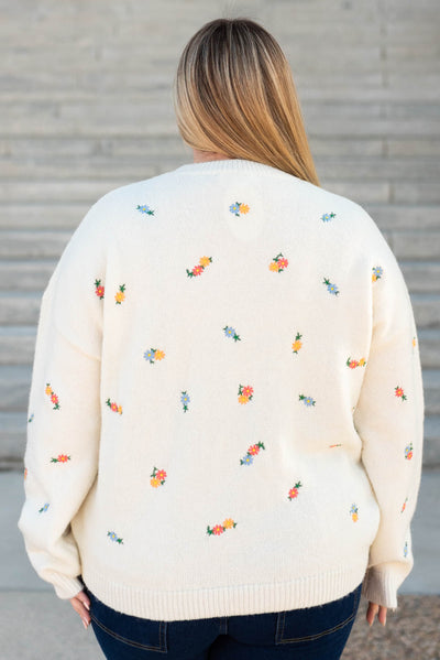 Back view of the plus size ivory floral embroidered sweater