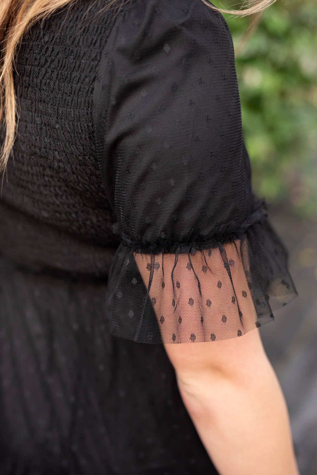 Close up of the sleeve on a black dress