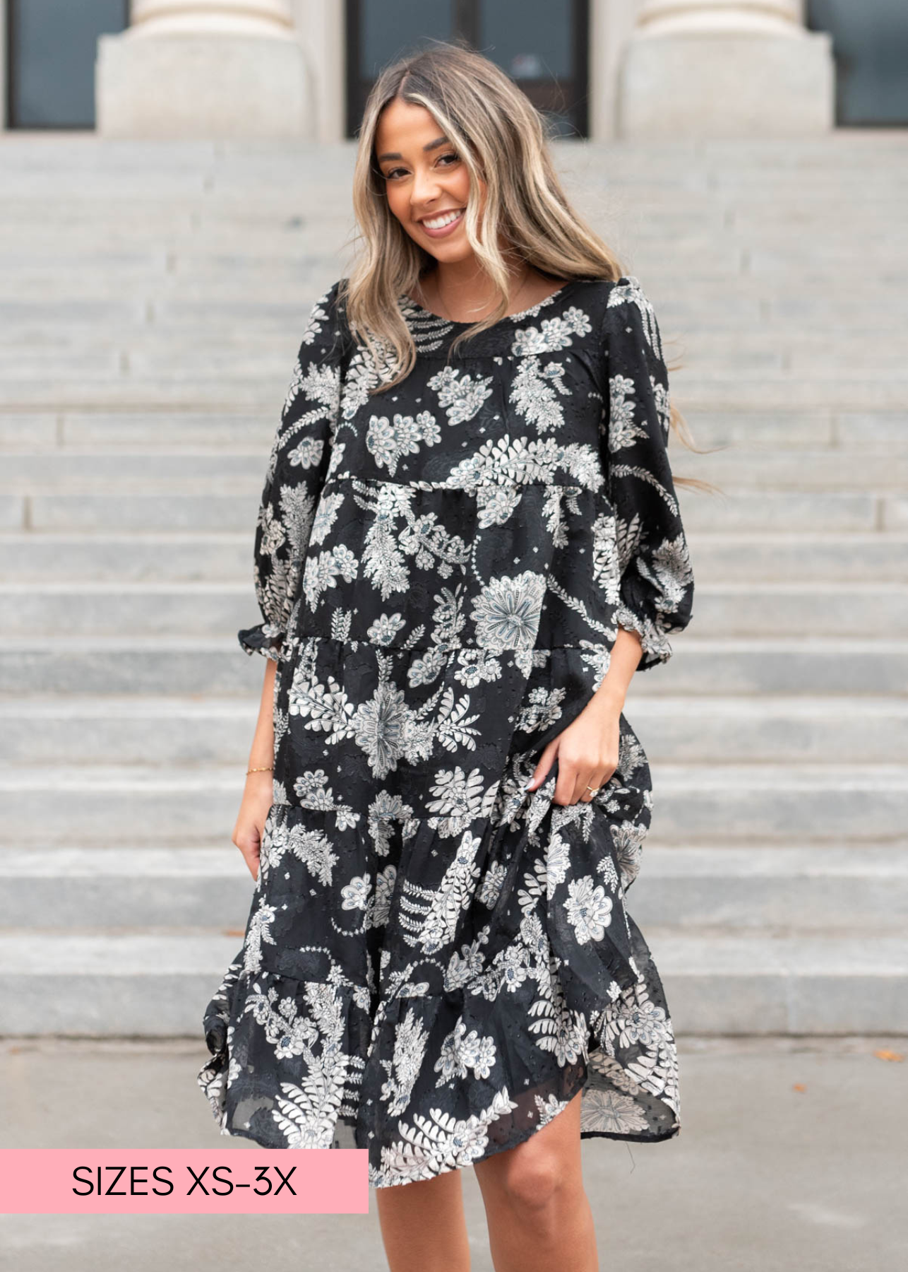 Front view of a knee length black floral dress