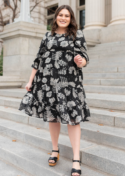 Black floral dress with 3/4 sleeves and tiered skirt