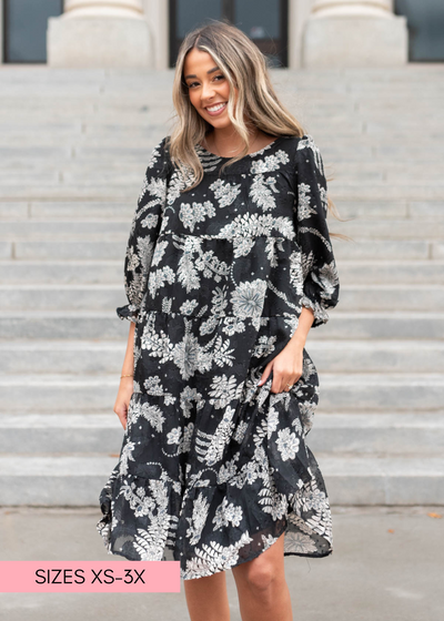 Short sleeve black floral dress with a ruffle at the hem