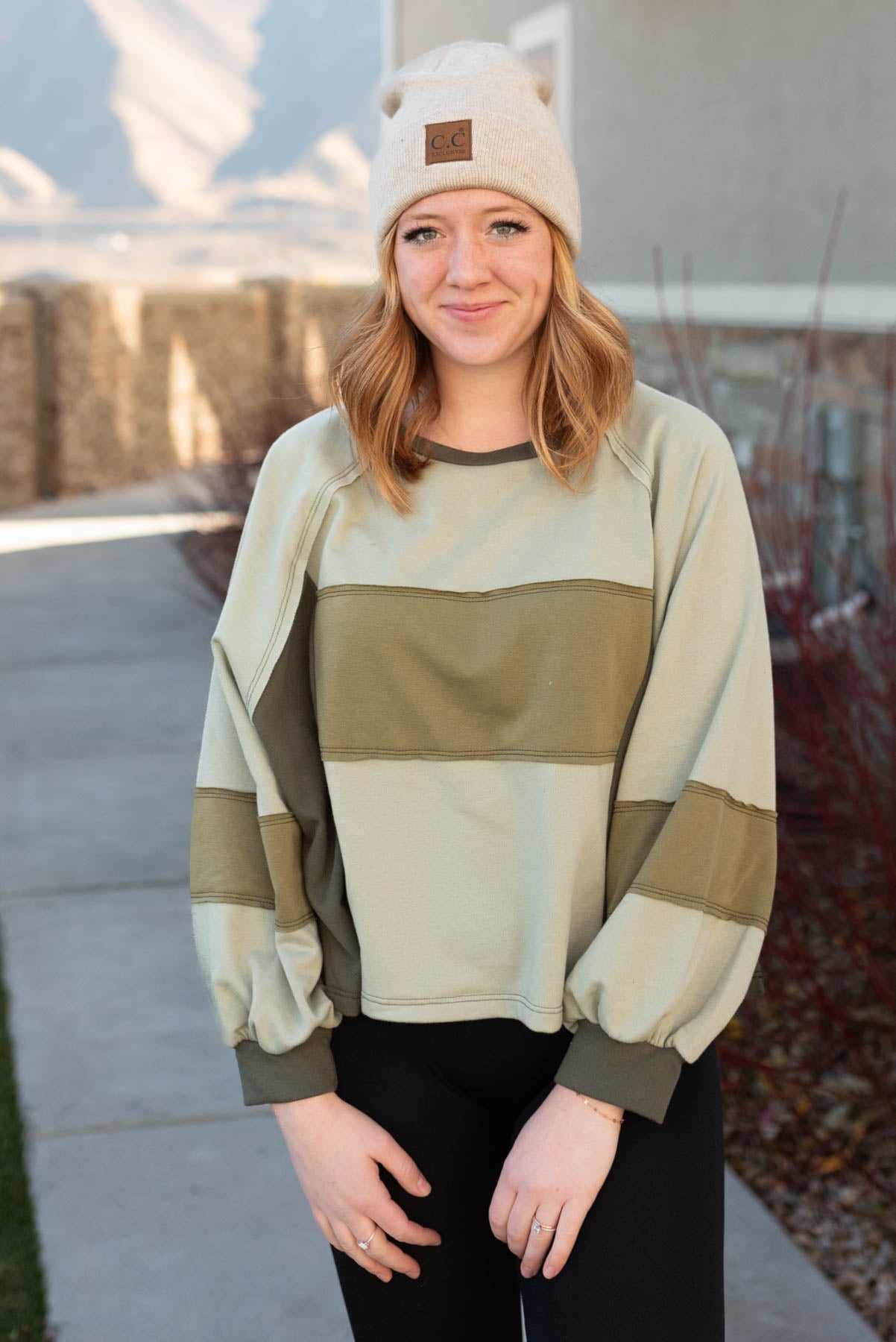 Front view of a olive block sweater